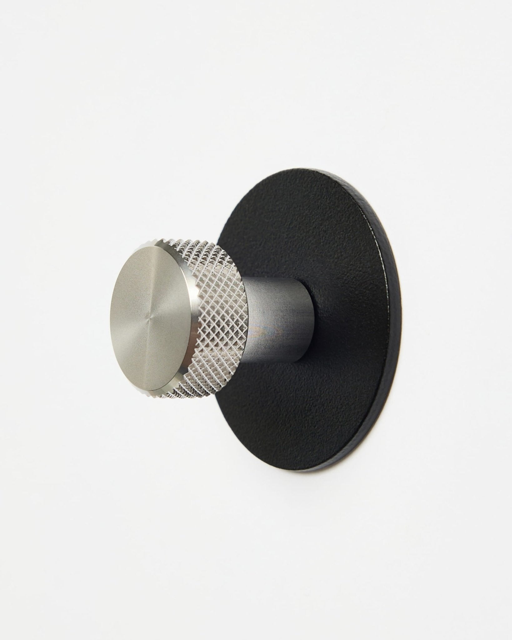 WoodUpp Norr | Coat Hook X1 i black och rostfritt steel installerad på en enkel vit vägg, utformad som ett tillbehör i CREATE-kollektionen för Akupanel system.